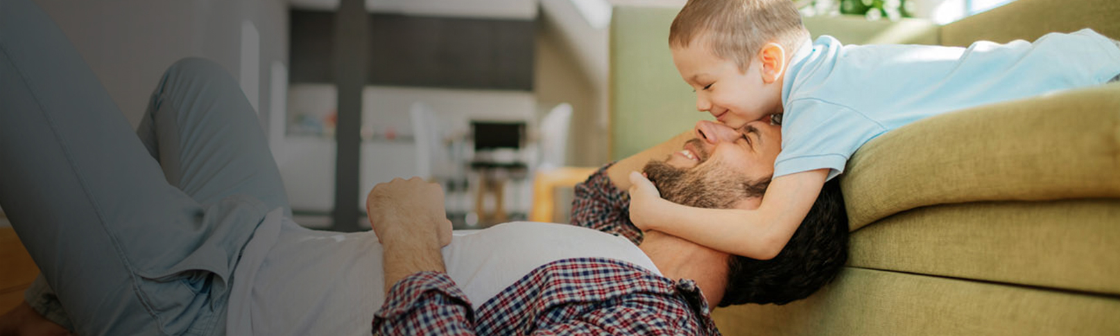 Father and Son Playing On the Couch