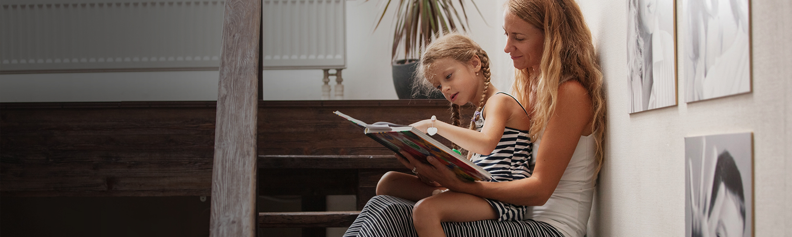 Mother and Daughter reading while sitting on the stairs