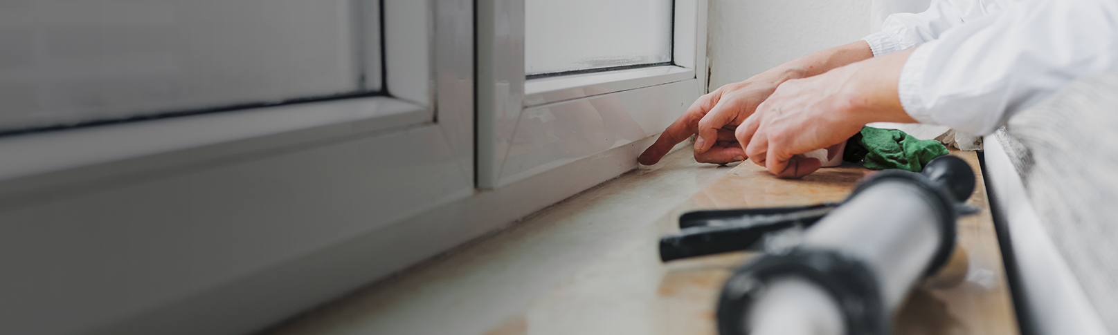 person repairing a house window