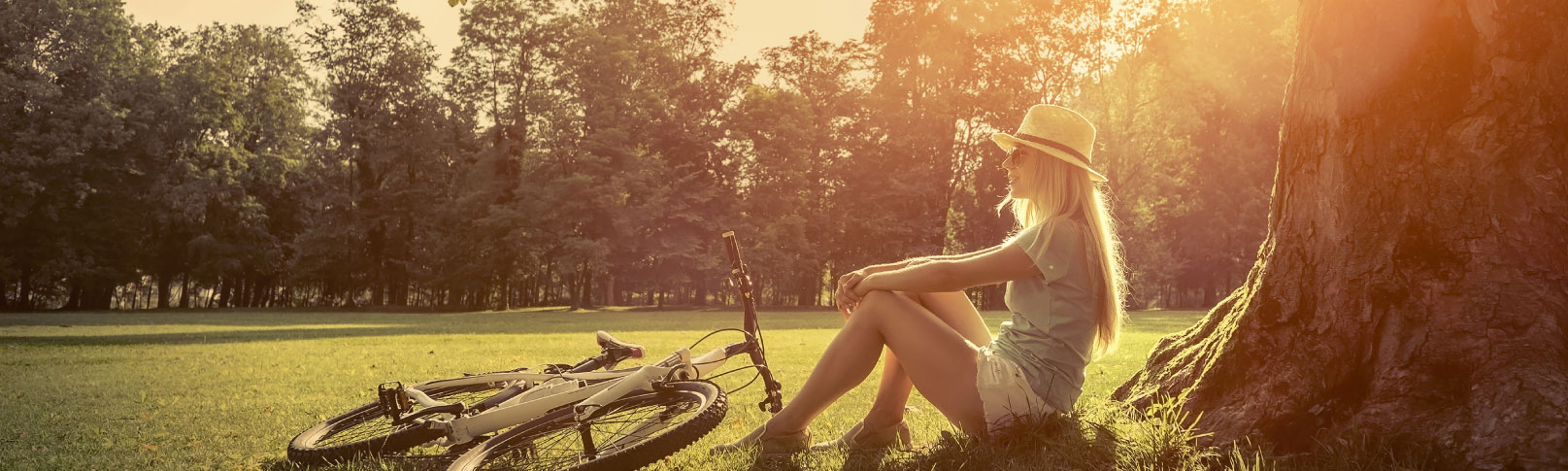 girl leaning against tree relaxing