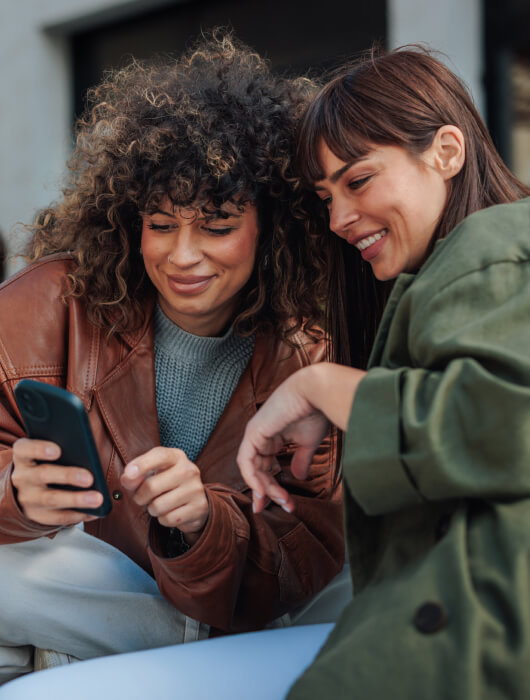 Young friends looking at mobile phone