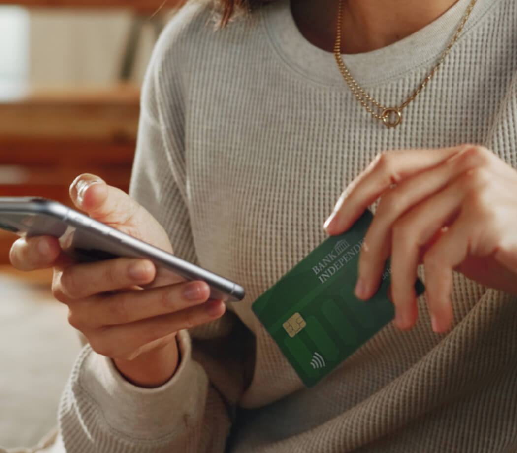 Close up of woman holding debit card